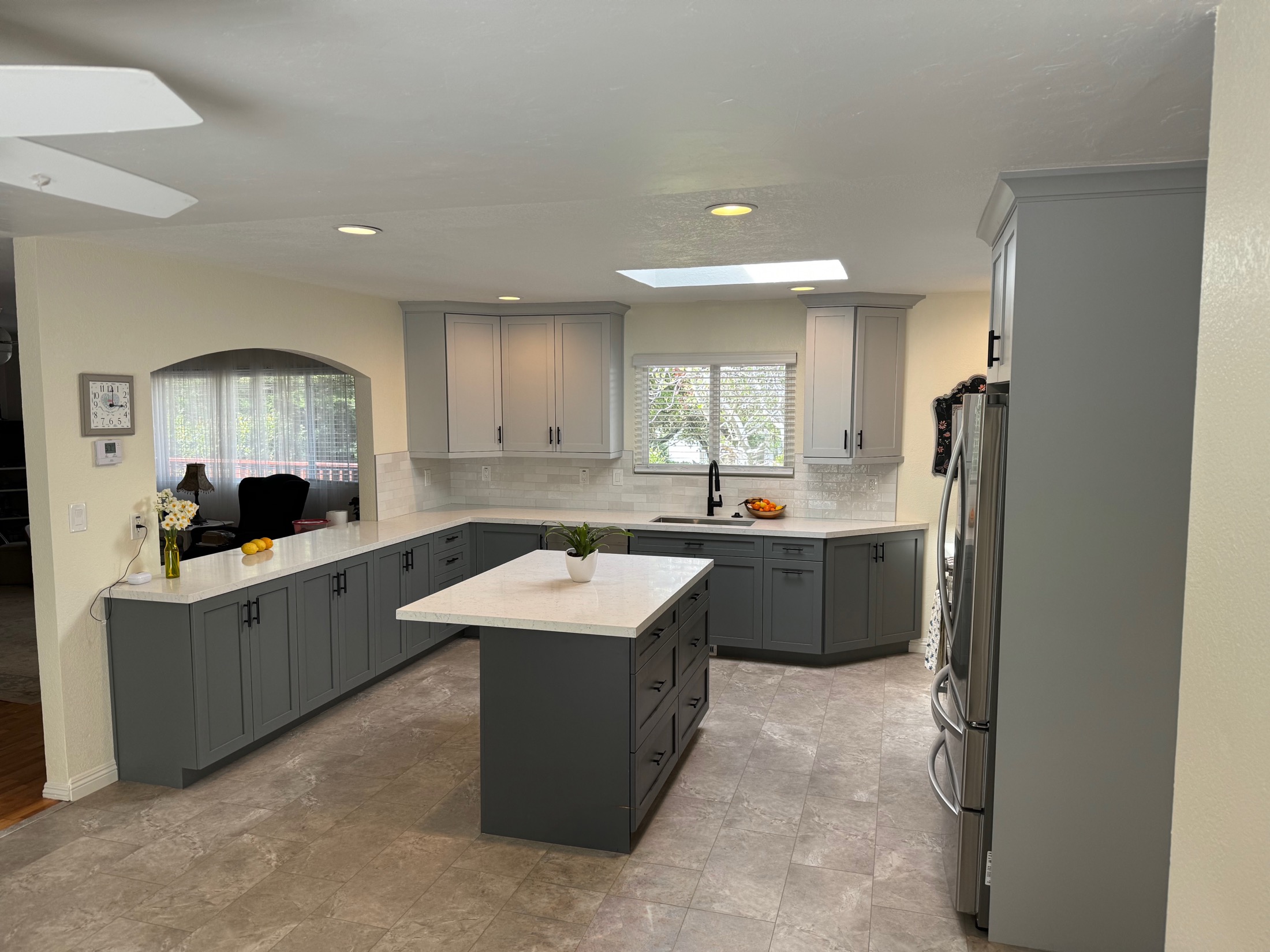 Aromas kitchen remodel with gray cabinets, marble counters, stainless appliances