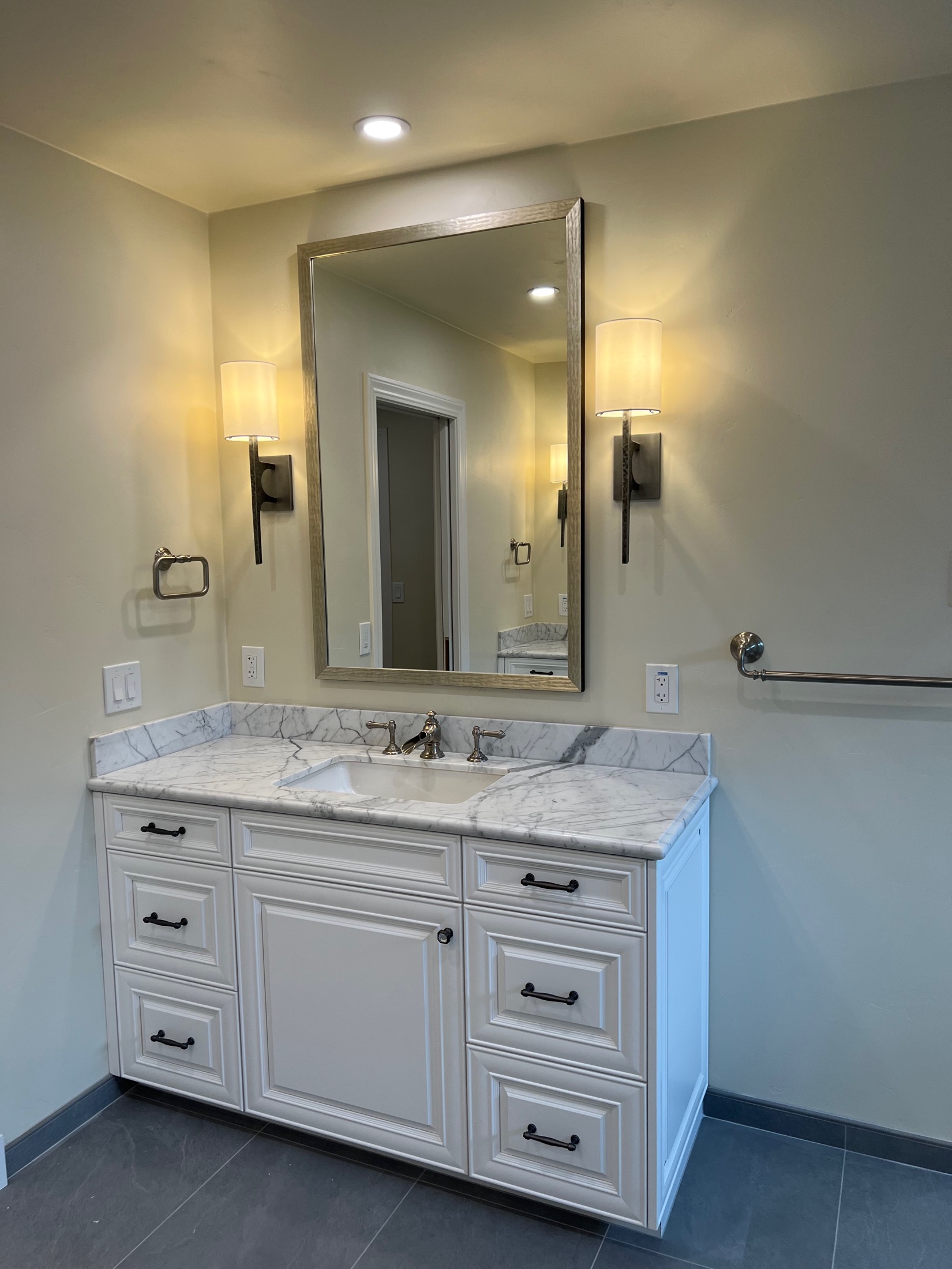 Carmel Valley bathroom single-sink vanity with marble countertop and framed mirror