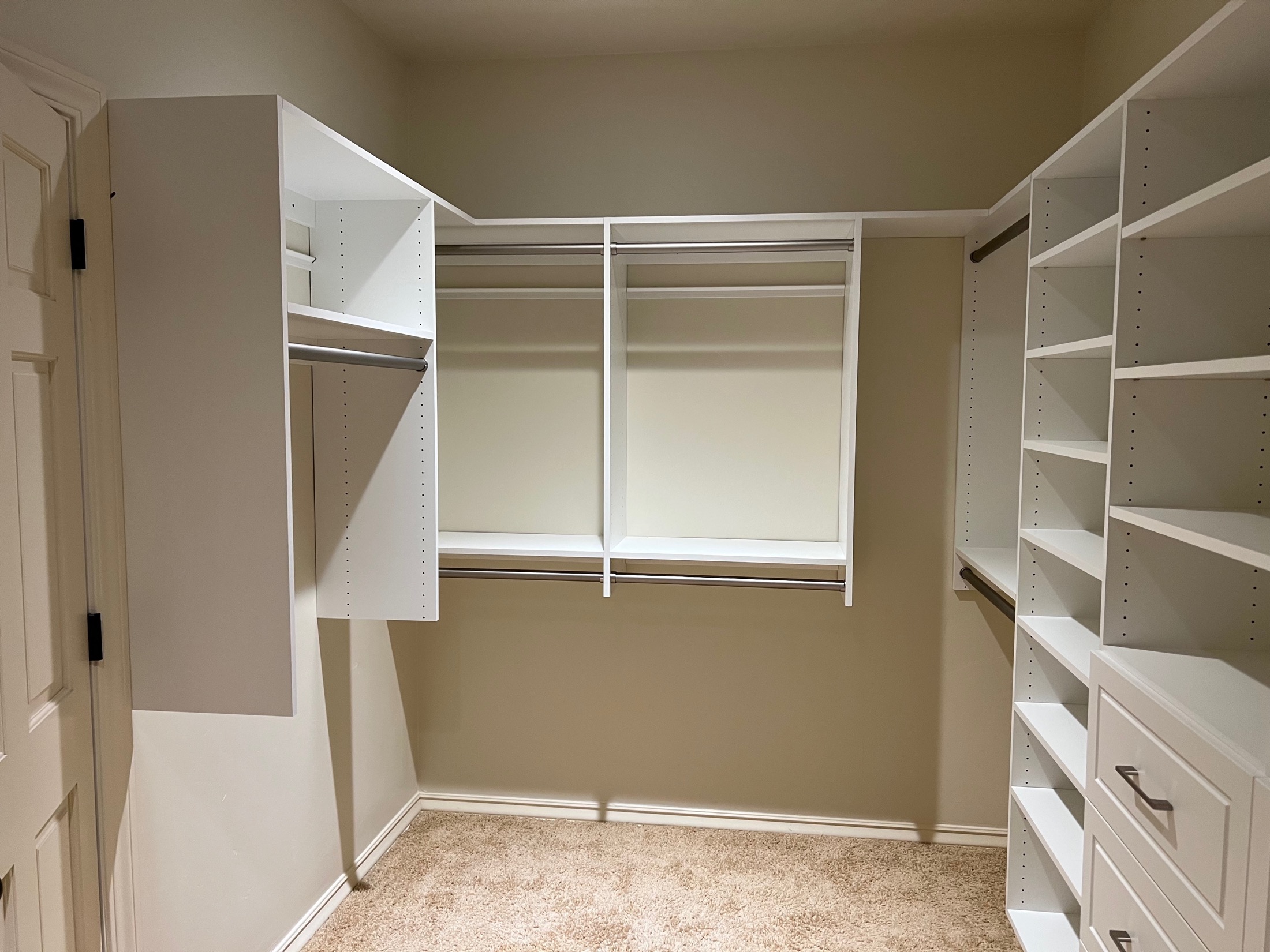 Custom walk-in closet with white shelving and organized storage in Carmel Valley home