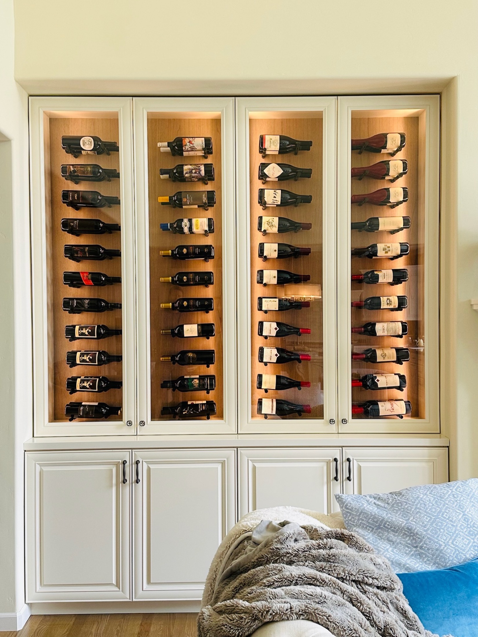 Custom built-in wine cabinet with glass doors and interior lighting in Carmel Valley home