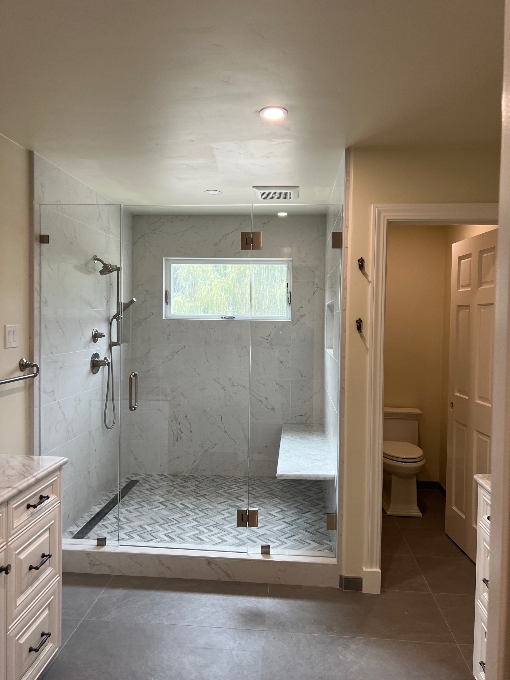 Carmel Valley master bath with walk-in marble shower and built-in bench