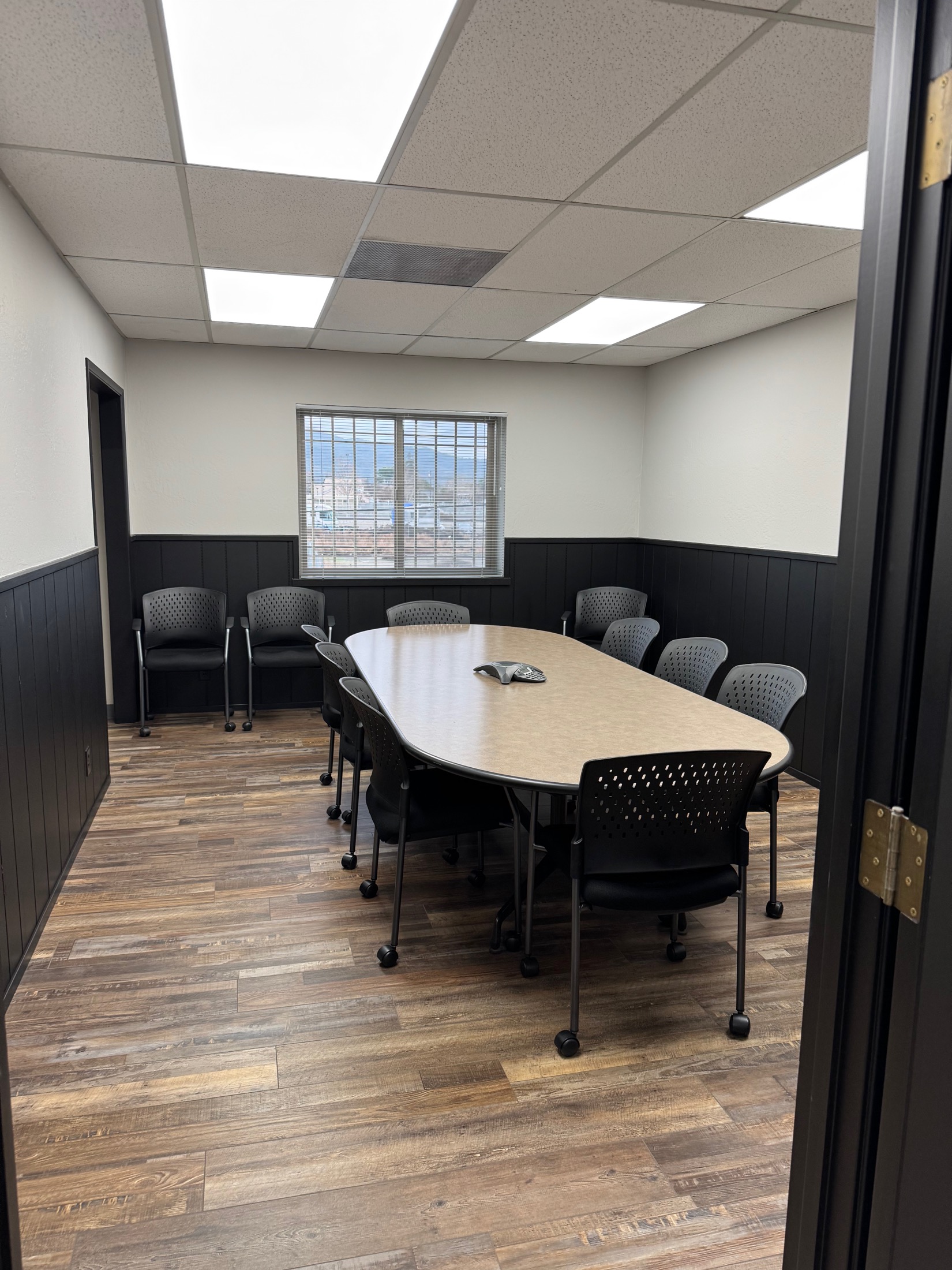 Gilroy commercial office — large conference room with window view and oval table