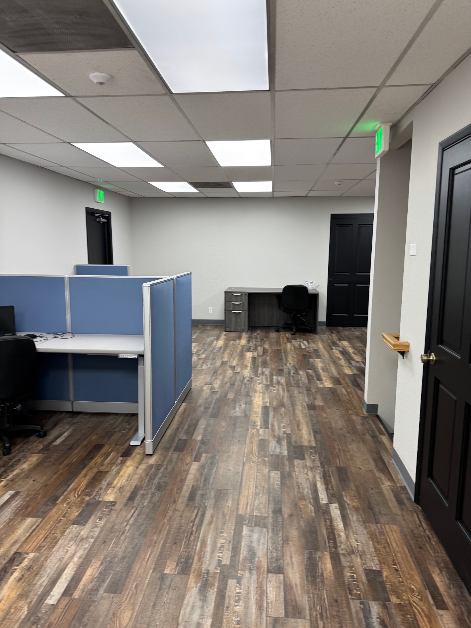Gilroy commercial office with blue cubicle partitions and LVP flooring