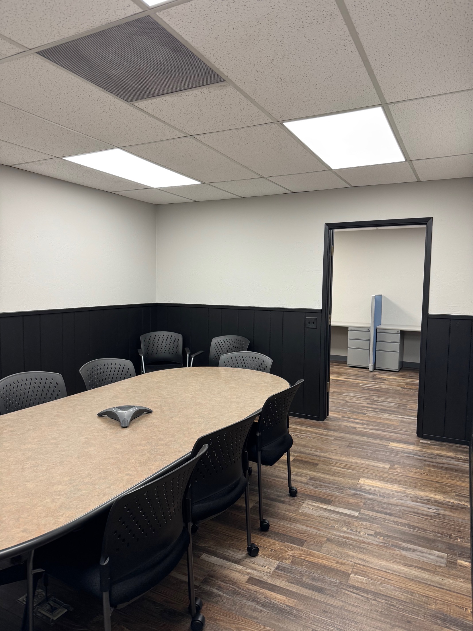 Gilroy commercial office — small conference room with black wainscot and LVP flooring
