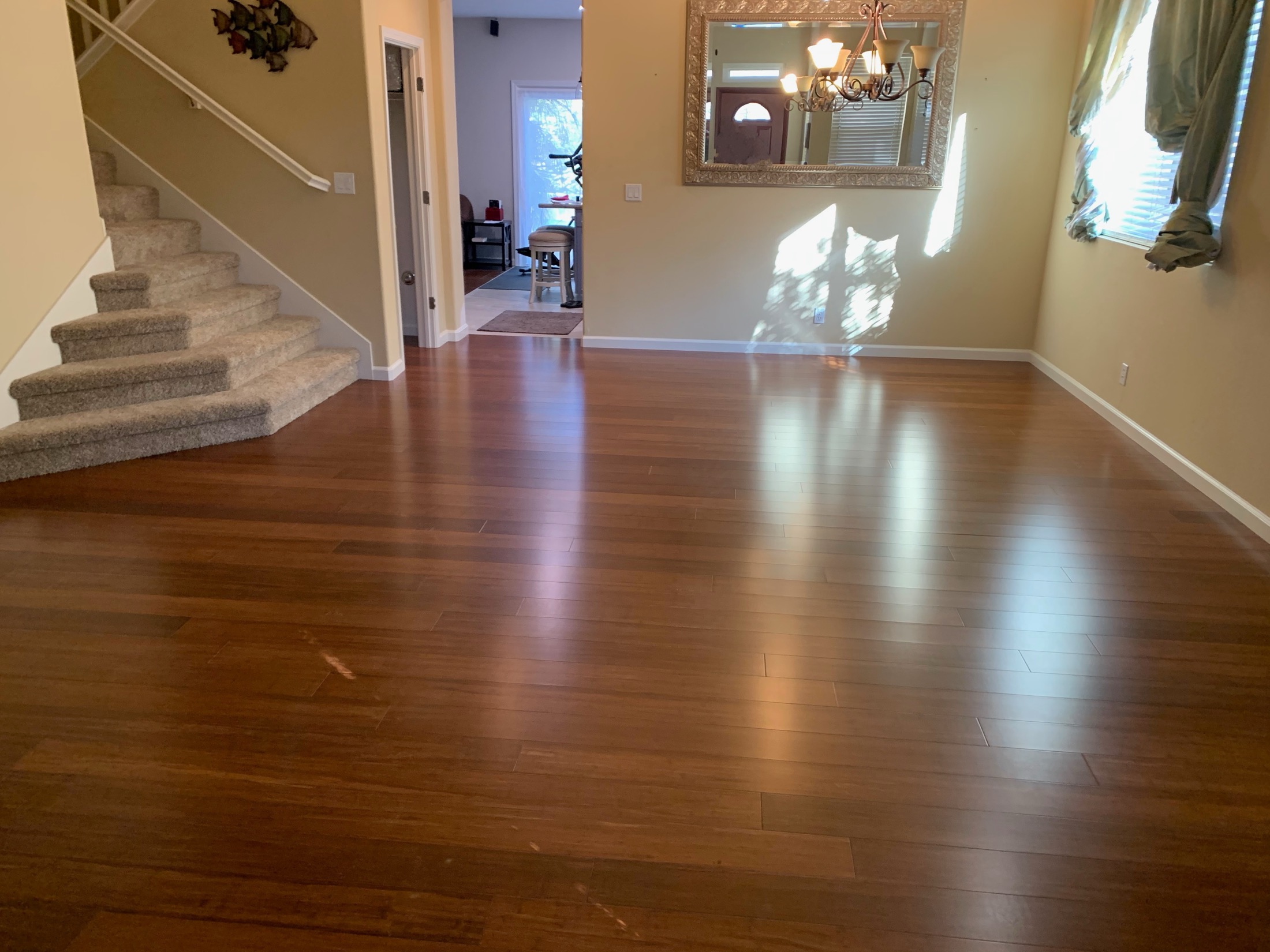 Dark bamboo flooring installation in Hollister home entry and dining area