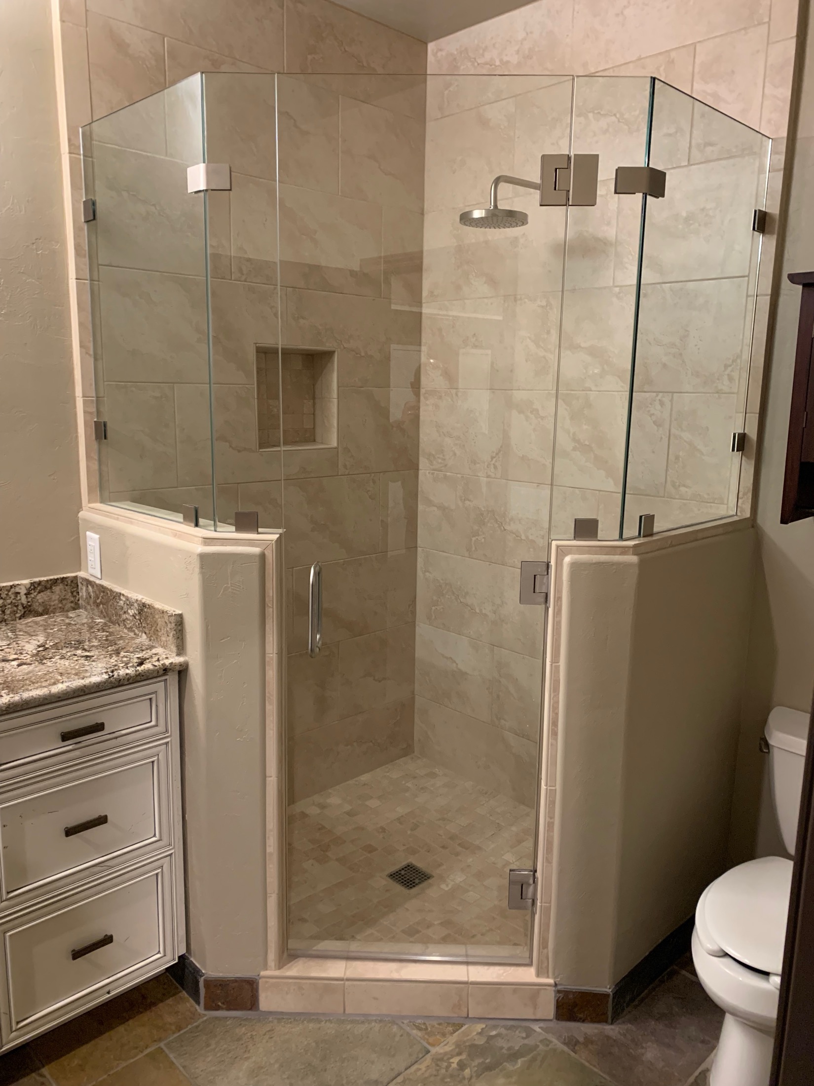 Hollister bathroom with travertine tile neo-angle frameless shower