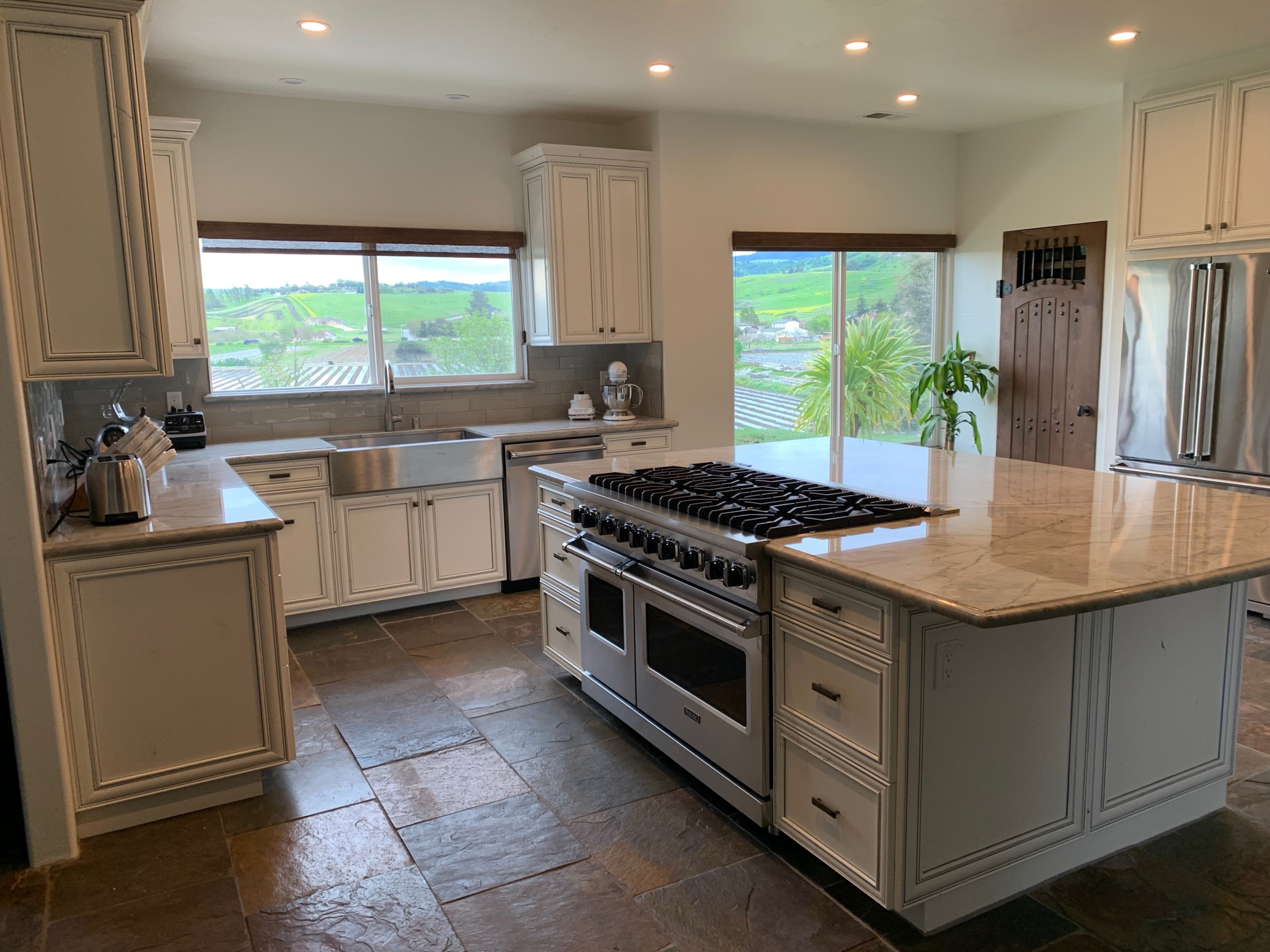 Hollister kitchen featuring farmhouse sink and Viking range on marble island