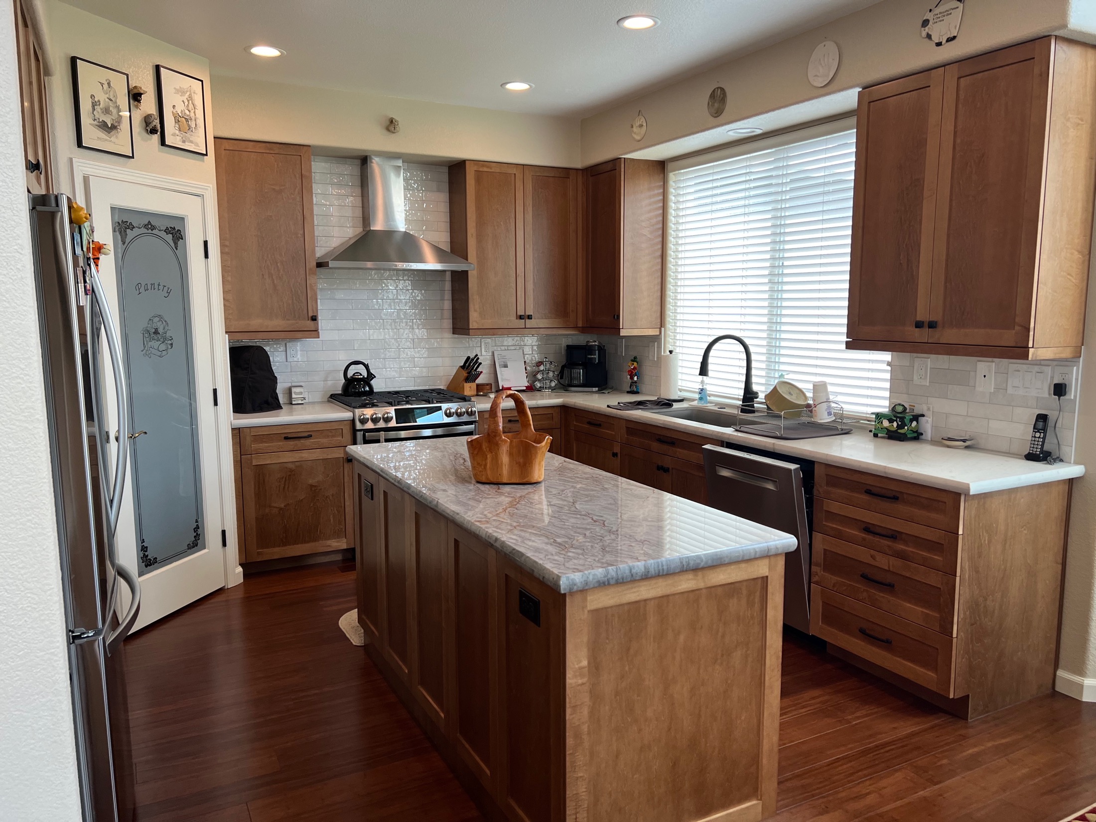 Hollister kitchen island in wood shaker cabinetry with marble countertop