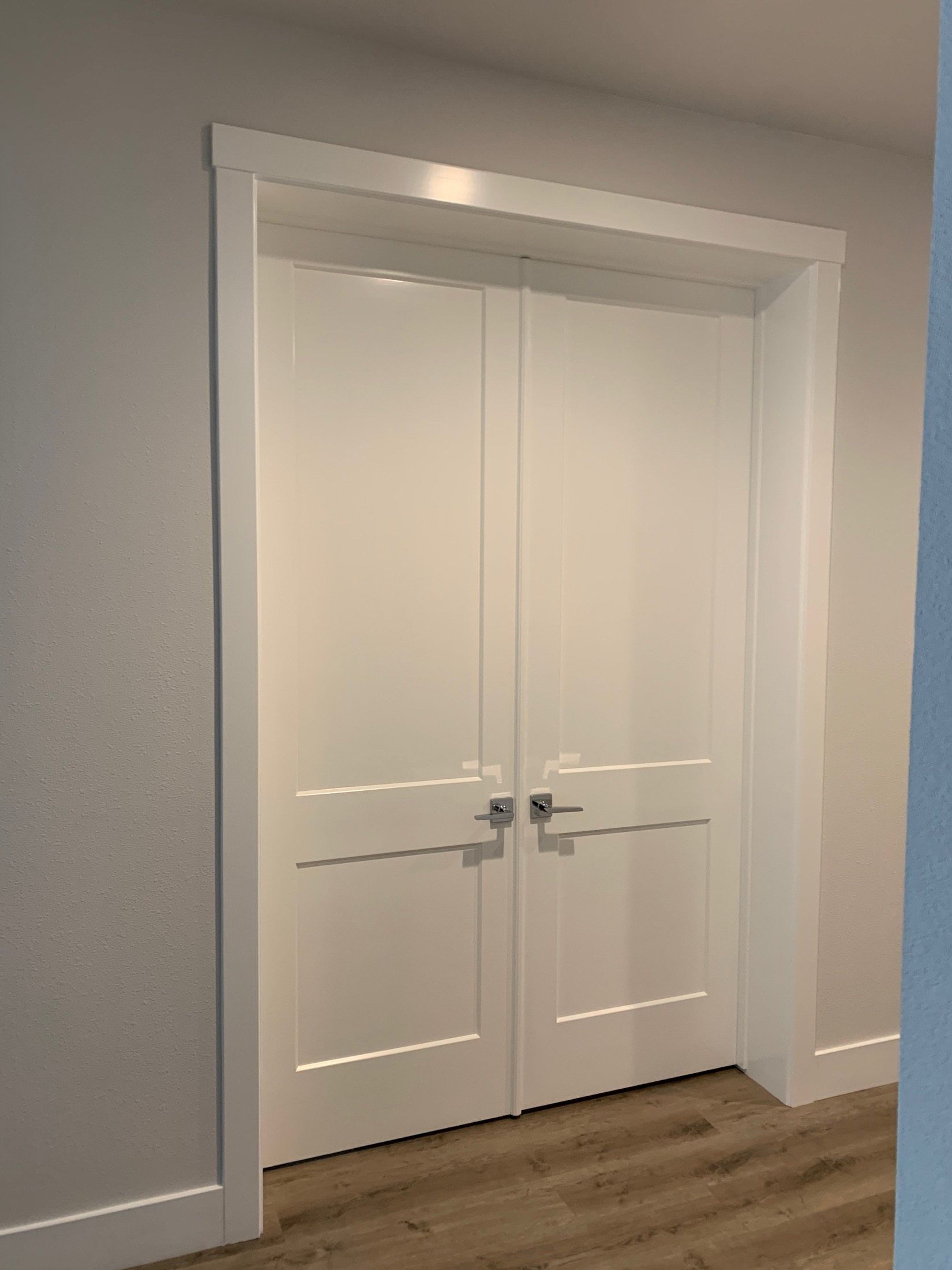 Custom double shaker interior doors with chrome lever handles in San Juan Bautista home